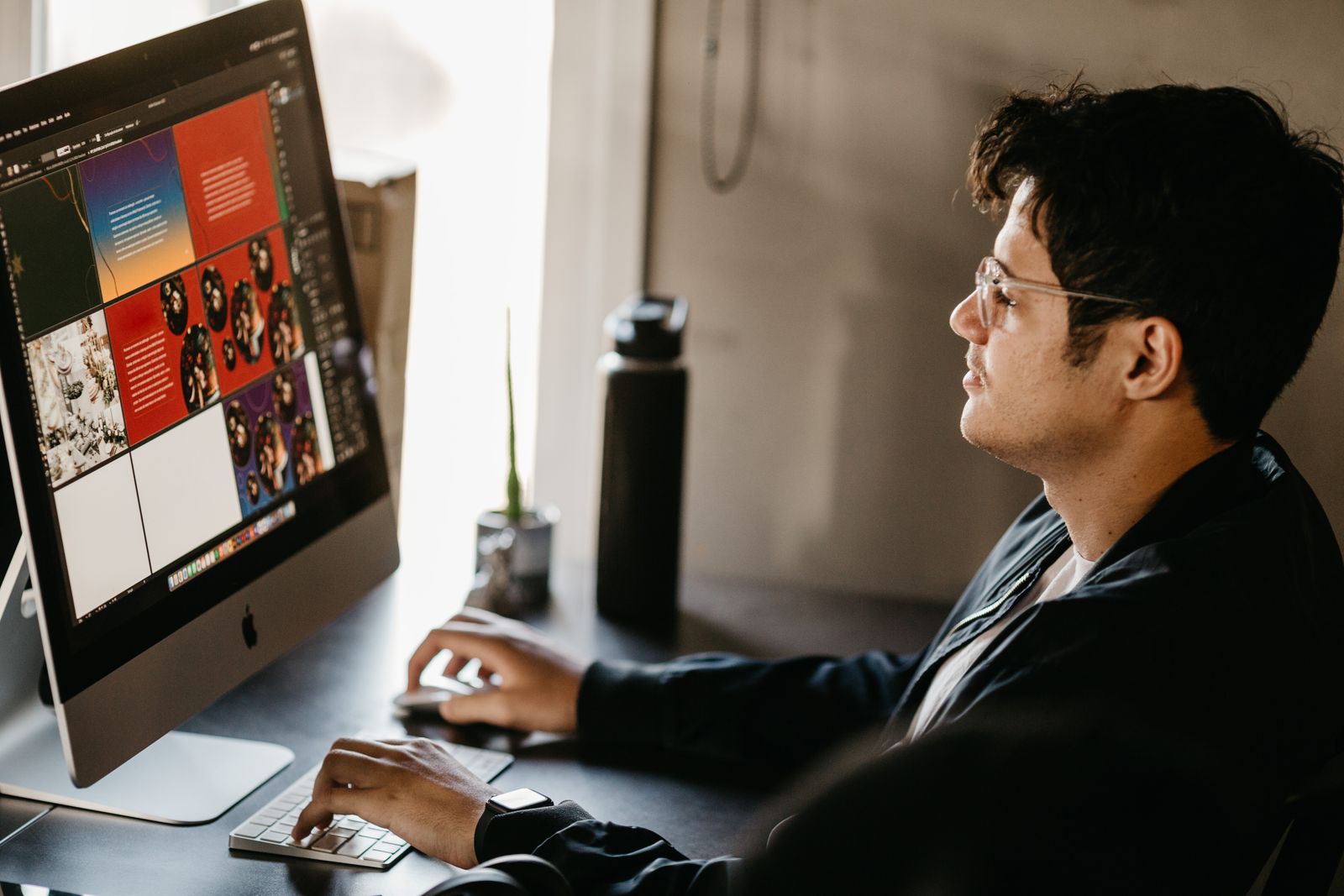 Designer reviewing layout work on a large monitor